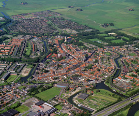 Fototapeta na wymiar Bolsward, Holland, July 12 - 1990: Historical aerial photo of the city Bolsward in the Dutch province Friesland