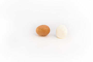 a brown chicken egg and an eggs boiled and peeled