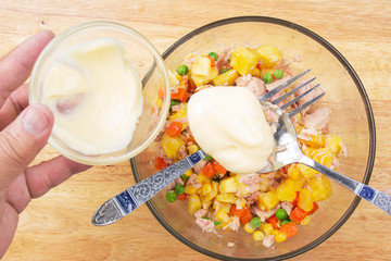 Chef putting cream salad for cooking Tuna corn salad