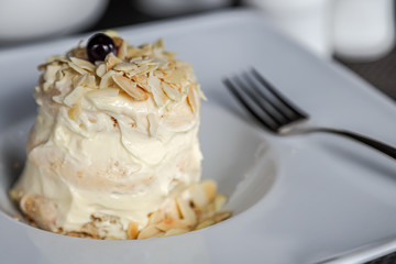 Sweet macaroon dessert on a plate with knife and fork. Cuisine sweet food. Soft focus.