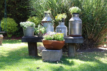 Garden decorations made with old milk containers and wood