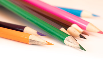 assorted colored pencils used for drawing and coloring on a white background