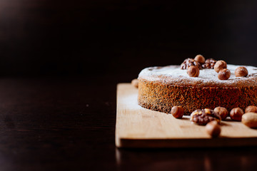 Biscuit with poppy seeds and nuts dusted with icing sugar. Homemade sponge cake with poppy seeds and nuts.