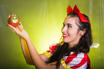 Woman holding hazardous radioactive apple. Nuclear and radiation measurement concept.