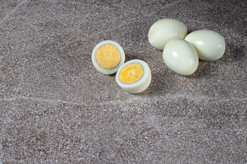 
Boiled peeled eggs without shell on a gray background. Ingredients for cooking.