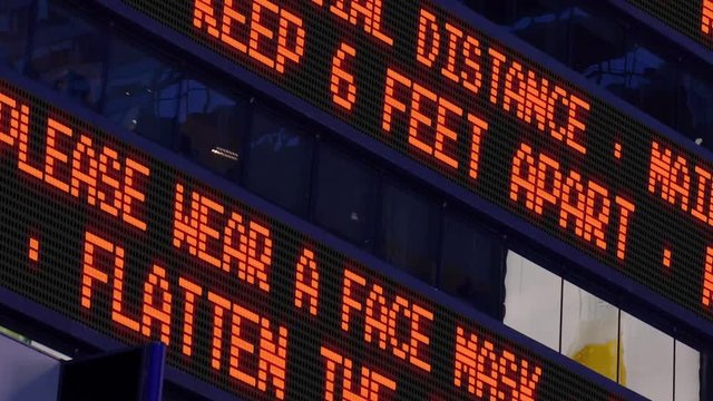 Closeup view of a Times Square stock market ticker reminding pedestrians to keep 6 feet apart from each other. Social distancing was a common practice to slow down the spread of COVID-19.