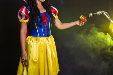Woman holding hazardous radioactive apple. Nuclear and radiation measurement concept.