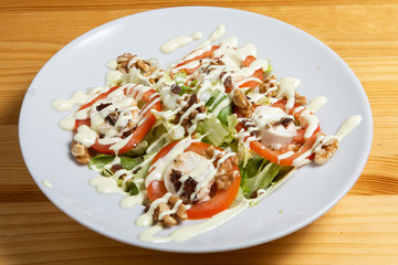 Salad with cheese, nuts and fresh vegetables.