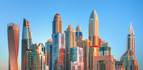 Obraz premium Amazing and Luxury Dubai Marina skyscrapers, famous Jumeirah beach skyscrapers at sunrise, United Arab Emirates