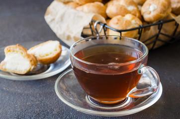 Tea and homemade profitroles pastry filled with custard.