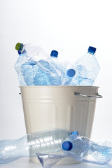 empty plastic water bottles thrown into the trash.