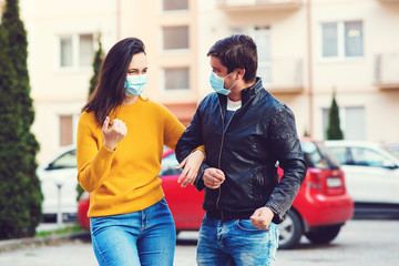 Young couple wearing face masks at street.