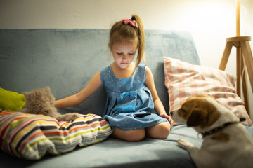 Girl of five looks at the phone