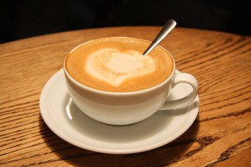 Close up cup of coffee on a wooden table