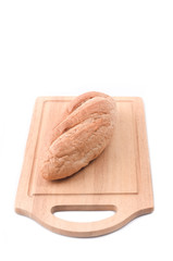 Sourdough Loaf on wooden cutting board isolated on white background