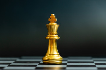 Gold king chess piece stand on black background (Concept for leadership, unique)