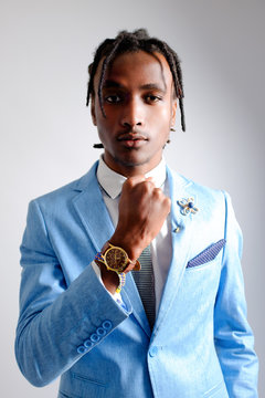 Good-looking African man wearing blue suit white shirt and grey tie stand