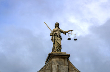 Statue of justice. Sky background. 
