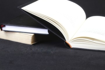 Opened book on black background