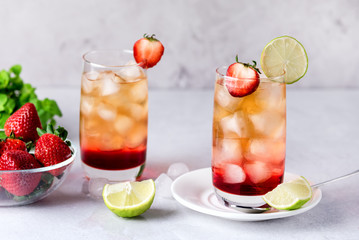 Glasses of Strawberries and Lime Ice Tea Refreshing Healthy Summer Drink Light Gray Background Horizontal