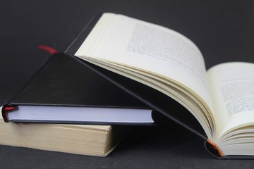 Opened book on black background