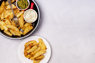 Roasted or Baked Potatoes With Spice in Black Bowl on Light Gray Background Tasty Homemade Dish Dinner Grilled Potatoes