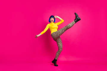 Full body profile photo of terrified lady raise leg up falling down slippery road wear retro specs yellow turtleneck blue wig boots leopard trousers isolated bright pink color background