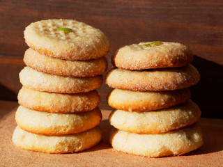 A stack of fresh appetizing cookies on a wooden background.