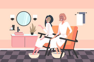 beautiful women applying face masks and foot basin with soap water girls in bathrobes relaxing skincare spa treatment concept bathroom interior horizontal full length vector illustration
