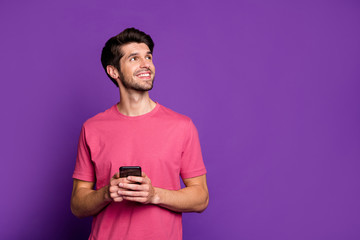 Portrait of positive cheerful addicted guy look copy space use smartphone inspired think what type...