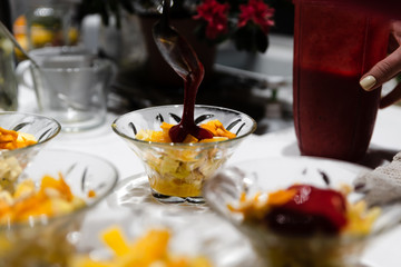 fresh fruit dessert jam poured on a white table,many desserts for the buffet,healthy vegetarian dessert with healthy fruits,fruit dessert for a healthy diet