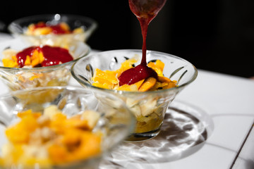 fresh fruit dessert jam poured on a white table,many desserts for the buffet,healthy vegetarian dessert with healthy fruits,fruit dessert for a healthy diet