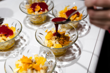 fresh fruit dessert jam poured on a white table,many desserts for the buffet,healthy vegetarian dessert with healthy fruits,fruit dessert for a healthy diet