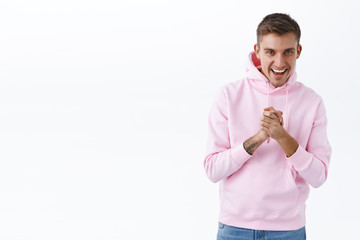 Portrait of enthusiastic handsome blond man ready for action, clasp hands together, rubbing palms as relish good deal, describe incredible event or party, inviting friend, smiling thrilled