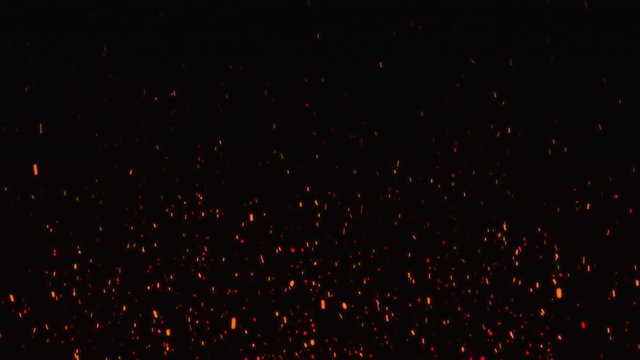 Fire embers particles over black background. Fire sparks background. Abstract dark glitter fire particle lights.