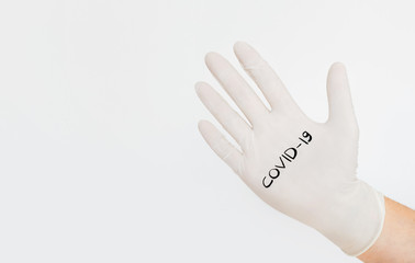 Close-up of hand in medical protecrive glove on light background. Corona virus Covid-19 concept