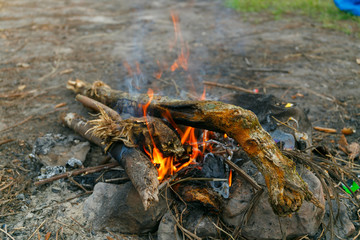 A campfire for cooking and give warm for people.