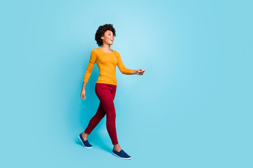Full size photo of positive cheerful dreamy afro american girl go walk enjoy free time holiday wear...
