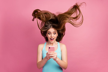 Portrait of her she nice attractive lovely charming cheerful cheery straight-haired girl using digital device 5g app ideal silky soft hair flying isolated on pink pastel color background