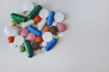 Many colorful pills on white background. Treatment against COVID-19 and others.