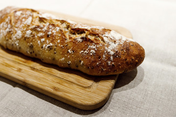 fresh bread on linen,bread lies on a cutting board,baked bread lies on the table,sliced ​​bread on linen background,home baked loaf,home made bread