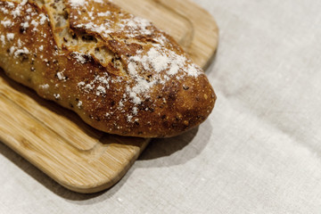 fresh bread on linen,bread lies on a cutting board,baked bread lies on the table,sliced ​​bread on linen background,home baked loaf,home made bread