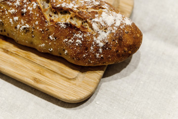 fresh bread on linen,bread lies on a cutting board,baked bread lies on the table,sliced ​​bread on linen background,home baked loaf,home made bread