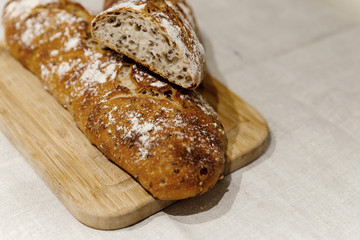 fresh bread on linen,bread lies on a cutting board,baked bread lies on the table,sliced ​​bread on linen background,home baked loaf,home made bread