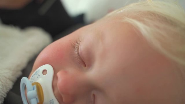 Mother giving a kiss to her son while sleeping