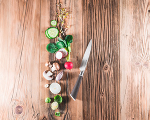 Cooking background with vegetables on wooden desk top-down frame