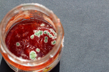 a red jam with mold on the surface - obrazy, fototapety, plakaty