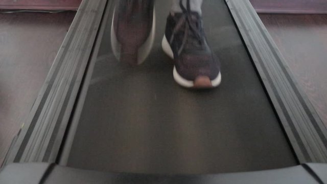 Close Up Shoot - Female Foots Running On Treadmill At Home.