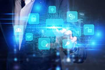 Business, Technology, Internet and network concept. Young businessman working on a virtual screen of the future and sees the inscription: Influence marketing