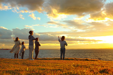 Christians praying for peace by sea, sunset background, faith, new coronavirus